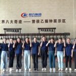 CLW Group factory staff team waving hello in showroom hall