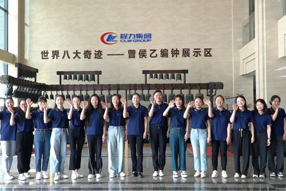 CLW Group factory staff team waving hello in showroom hall