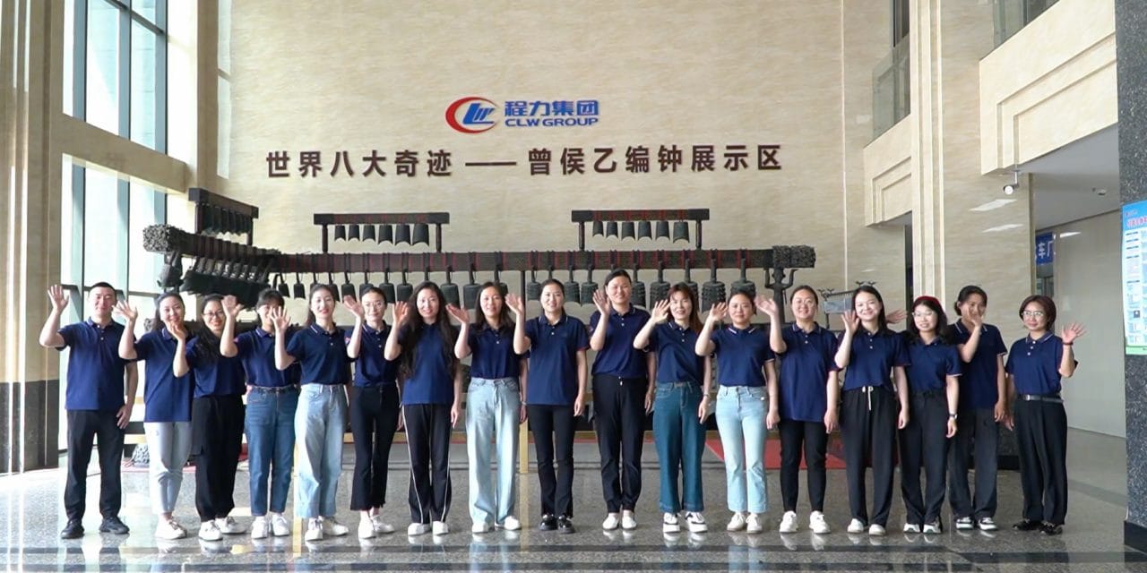 CLW Group factory staff team waving hello in showroom hall