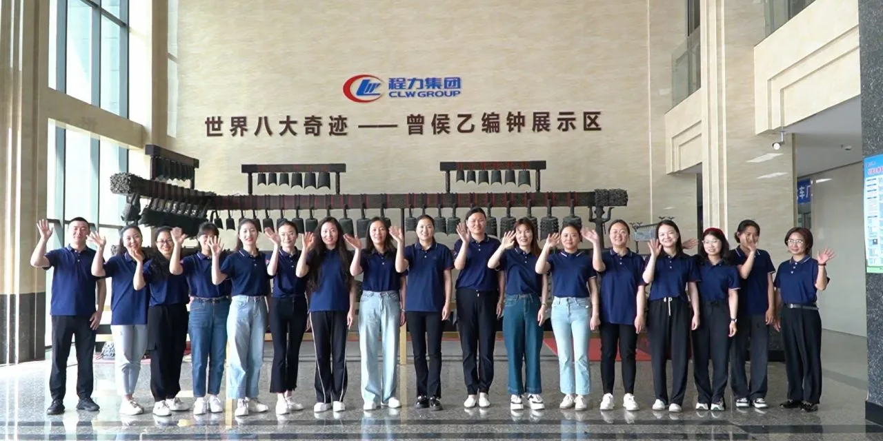 CLW Group factory staff team waving hello in showroom hall
